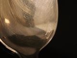 a silver spoon that is sitting on top of a table
