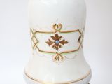 a white vase with a gold and blue design on it