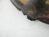 a close up of a metal object on a white surface