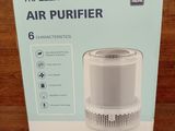 the box of the air purifier is open on the table