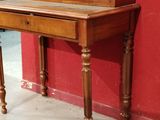 a wooden desk with a drawer on top of it