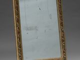 an image of a gold framed mirror on a grey background