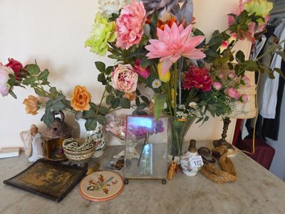 a table with a vase of flowers and a book on it