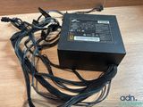a close up of a computer power supply on a wooden table