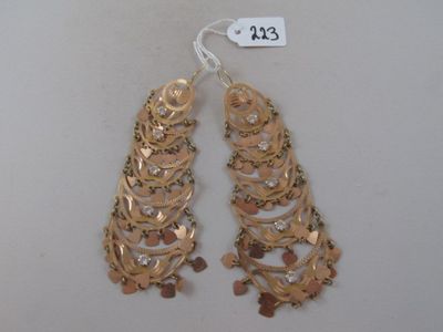 pair of gold tone earrings with dangling chains and dangling beads