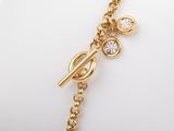 a close up of a gold bracelet with diamonds on it