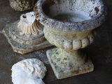 many different types of stone vases on the floor