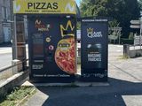 two vending machines sitting on the side of the road