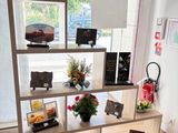 a room with a table and a shelf with pictures on it