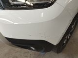 a close up of the front bumper of a white car