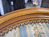 a close up of a wooden chair with beads on it