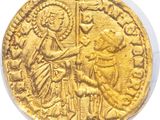 a close up of a gold coin with an image of a man holding a sword