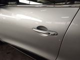 a silver car that has a door handle on it