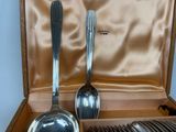 two spoons and two spoons in a case