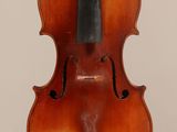 an old violin with a bow hanging from it ' s back