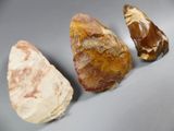 three different types of rocks on a gray surface