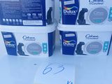 three containers of cat litter sitting on top of a white table