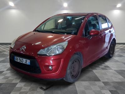 the small red car is parked in a large room