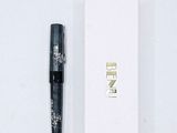 a pen that is laying next to a white box