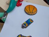 a little mermaid sitting on top of a piece of paper next to a pair of shoes