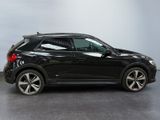 the rear end of a black volkswagen suv parked in a garage