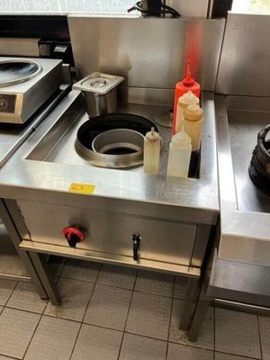 a stove with a pot on top of it in a kitchen