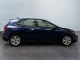 the blue car is parked on the concrete floor in the room