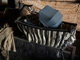 a basket full of clothes sitting on the floor of a room