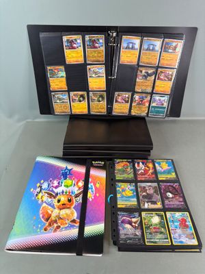 a collection of pokemon trading cards on display on a table