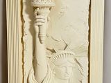 sculpture of statue of liberty holding a torch in a frame