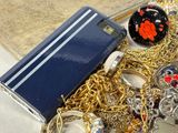 a pile of gold and silver jewelry on a table