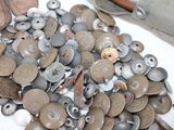 a pile of old buttons on a white table