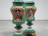 pair of green and gold vases with figures painted on them