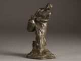 bronze statue of a woman holding a basket on a pedestal