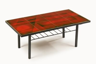 an image of a red table with black legs and a red table top