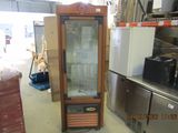 a glass display cabinet in the middle of a room