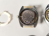 two watches sitting next to each other on a table
