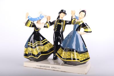 two figurines of a couple dressed in blue and black
