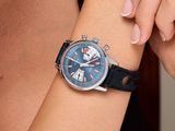 someone is holding a wrist with a watch on it that is on a woman ' s arm