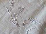a close up of a table cloth with a flower on it