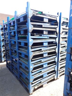many pallets that are stacked up on the ground