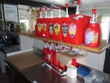 a counter with a bunch of red containers on it