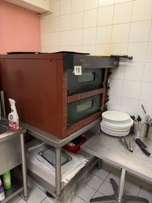 a kitchen with a sink, microwave, and other items on the counter