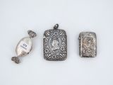 three pieces of silver jewelry including a locke, a watch and a pendant
