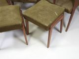 four green chairs and a table with a white table top