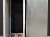 a metal cabinet with a door open and a pallet in front of it