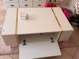 a white coffee table with a gold stripe on it