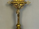 a gold cross with a crucifier on it