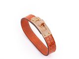 a brown leather bracelet with a gold clasp