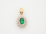 an emerald and diamond pendant on a white background